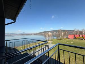 a view of a lake from the balcony of a house at Noclegi Laguna in Żywiec