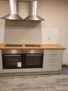 a kitchen with a counter with a stove top oven at Heavenly Apartment in Woodside