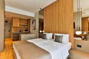 a bedroom with a large bed and a kitchen at Regent Resort Budva in Budva