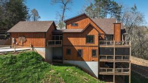 a large wooden house on top of a hill at Jazzy's Cozy Creekside in Blue Ridge