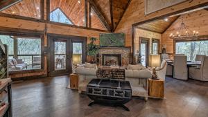 a living room with a fireplace in a wooden house at Jazzy's Cozy Creekside in Blue Ridge