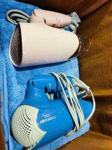 a hair dryer sitting on top of a blue towel at 池袋House3F Cozy for 1-3 guests in Tokyo