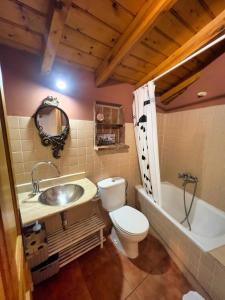 a bathroom with a toilet and a sink and a tub at Apartamentos Las Casucas de Gema in Isla +44 photos