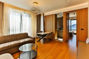 a living room with a couch and a table at Regent Resort Budva in Budva