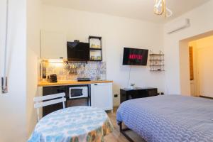 a small bedroom with a bed and a kitchen at Casa Remy in Cagliari +13 photos