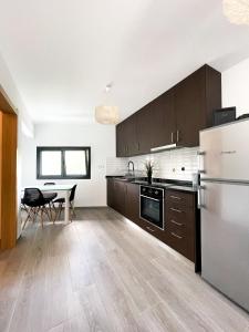 eine leere Küche mit einem Tisch und einem Kühlschrank in der Unterkunft Royal House AL in Rio Caldo