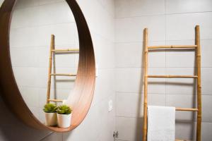 a bathroom with a mirror and two potted plants at Royal House AL in Rio Caldo