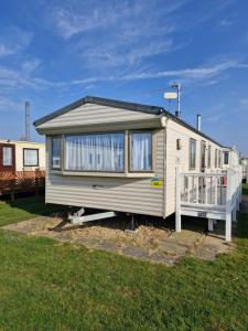 a tiny house is parked in a yard at Seaview 157 - Ingoldmells - Meadow Lakes Caravan & Lodge Hire in Ingoldmells