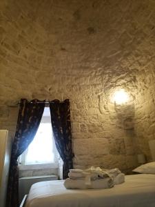 Posteľ alebo postele v izbe v ubytovaní Trulli in Martina Franca residence