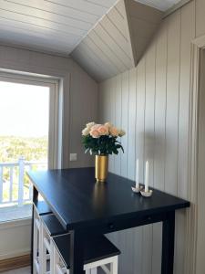 a black table with a vase of flowers on it at Sjåen Panorama in Kragerø +12 photos