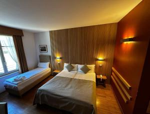 Postel nebo postele na pokoji v ubytování Hotel Cortese