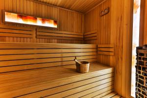 a wooden sauna with a bucket in it at Regent Resort Budva in Budva