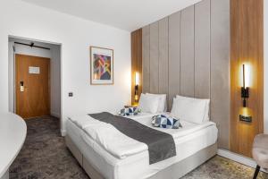 Postel nebo postele na pokoji v ubytování Hotel Soimul