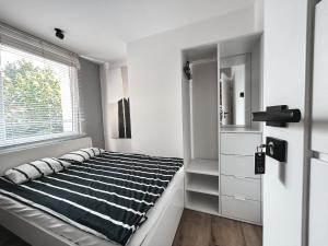 a bedroom with a bed and a window at Hostel 19 Sopot in Sopot