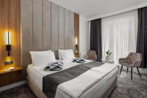 Postel nebo postele na pokoji v ubytování Hotel Soimul
