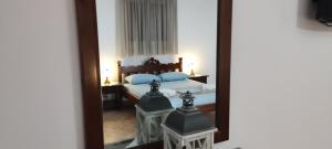 a bedroom with a bed and a mirror at Chrysiis House 2 in Maltezana