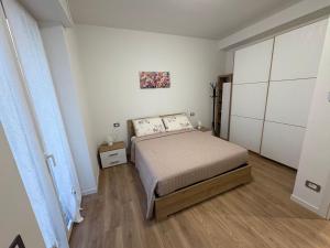 a small bedroom with a bed and a cabinet at Focolare Manzoni in Lecco