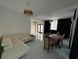 a living room with a white couch and a table at Lux Vila Lake in Ovidiu