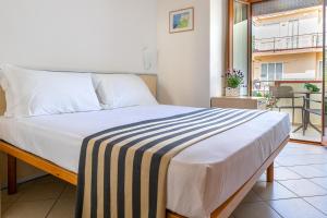 a bed in a room with a balcony at Grazia Hotel in Sperlonga +49 photos