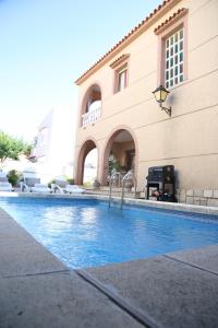 a swimming pool in front of a building at MD Chalet con piscina Mareny Beach in Mareny Blau