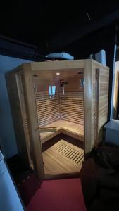 a small wooden enclosure with two chairs in it at Apartment Sport & Sauna Prague in Prague