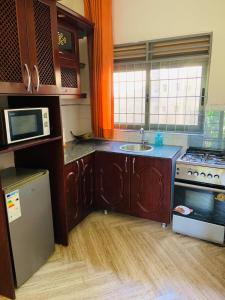 a kitchen with a sink and a microwave at Pleasant Places in Kabubu