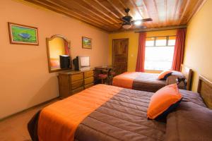 Postel nebo postele na pokoji v ubytování Hotel Cipreses