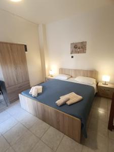 a bedroom with a bed with two towels on it at Iskas apartments in Ialysos
