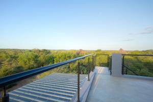 a balcony of a house with a viewing deck at Giraffe Oasis - Kruger Luxury Family Villa in Marloth Park +89 photos