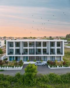 an office building with a car in a parking lot at Studio D1 in Kallithea Halkidikis
