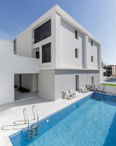 a house with a swimming pool in front of a building at Studio D1 in Kallithea Halkidikis