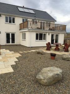 a house with a backyard with a table and a rock at Bro Dafydd in Aberystwyth