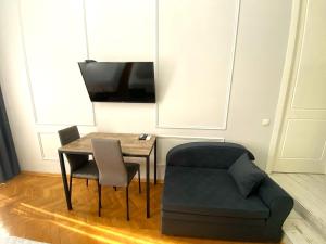 a living room with a table and a chair at Aparthotel Mtatsminda in Tbilisi City
