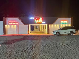 a car parked in front of a fast food restaurant at Hotel Tulsi inn in Ellora +20 photos