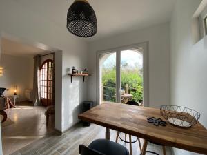 a dining room with a table and a large window at Villa Roka in Six-Fours-les-Plages