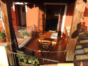 a balcony of a house with a table and chairs at Casa Cala Luna in Santa Maria Navarrese