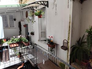 a balcony with potted plants on the side of a building at ciclopi in Palermo