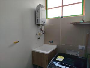a small bathroom with a sink and a window at Relájate Cerca del Malecón con un Barril Asador para Tus Parrilladas in Guatapé +13 photos