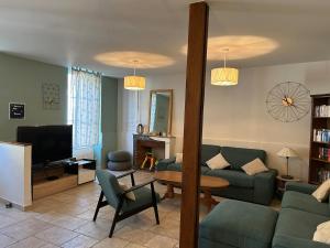 a living room with a couch and a tv at Maison de ville, Gien centre in Gien
