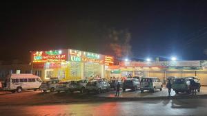 a group of cars parked in a parking lot at night at Hotel Tulsi inn in Ellora