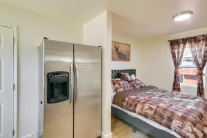 a bedroom with a refrigerator next to a bed at Studio 2 Mi to Feather River Bring Your Pet! in Oroville