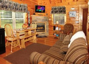 a living room with a couch and a table and a fireplace at A Bit of Heaven in Cosby
