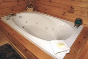 a white bath tub with a towel sitting in it at A Bit of Heaven in Cosby +11 photos