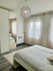 a bedroom with a large mirror and a bed at Appartement Reims in Reims