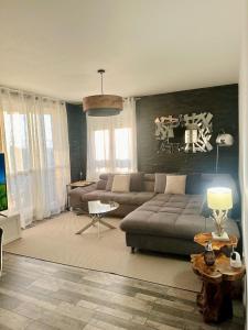 a living room with a couch and a table at Appartement Reims in Reims