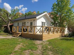 a house with a wooden deck in front of it at Newly built house at central location in Strängnäs in Strängnäs