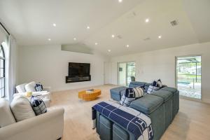 a living room with two couches and a tv at Private Pool, Patio and Peace Marco Island Getaway in Marco Island