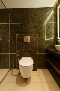 a bathroom with a toilet and a sink at Monte Verde in Dehradun