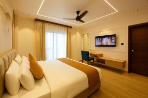 a hotel room with a bed and a television at Monte Verde at Rajpu Road by Zenvana in Dehradun