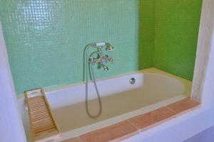 a bath tub with a shower in a bathroom at Country house Grencaia in Chianciano Terme +41 photos